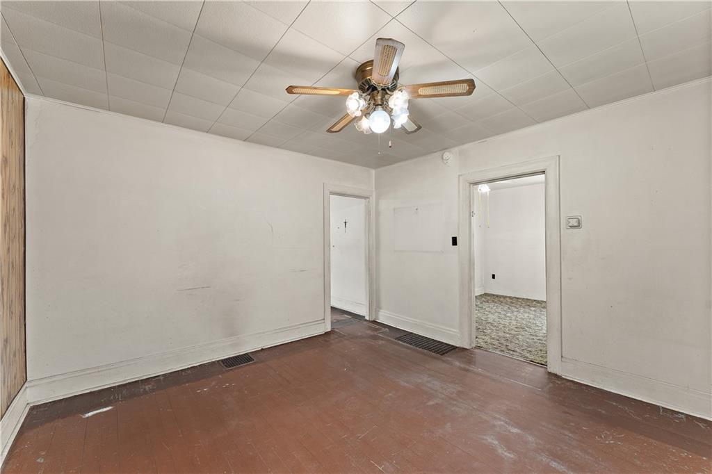 104 W Road Pittsburgh, PA 15209 - Photo 10 of 40 an empty room with a chandelier fan and windows