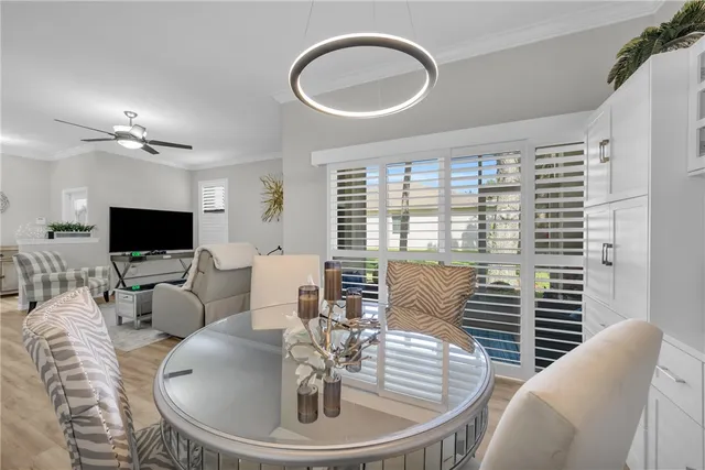 a living room with furniture a large window and a flat screen tv