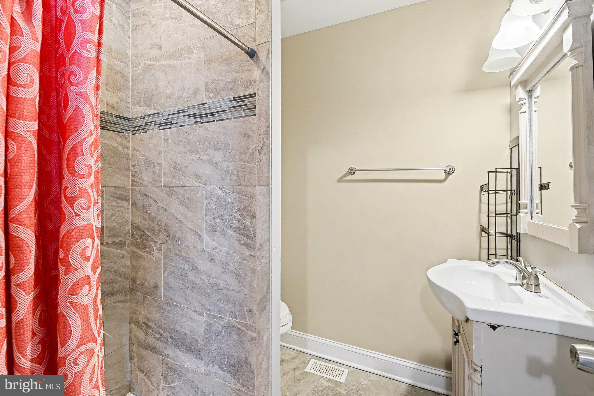 8716 Eddington Road Parkville, MD 21234 - Photo 12 of 27 a bathroom with a sink and mirror