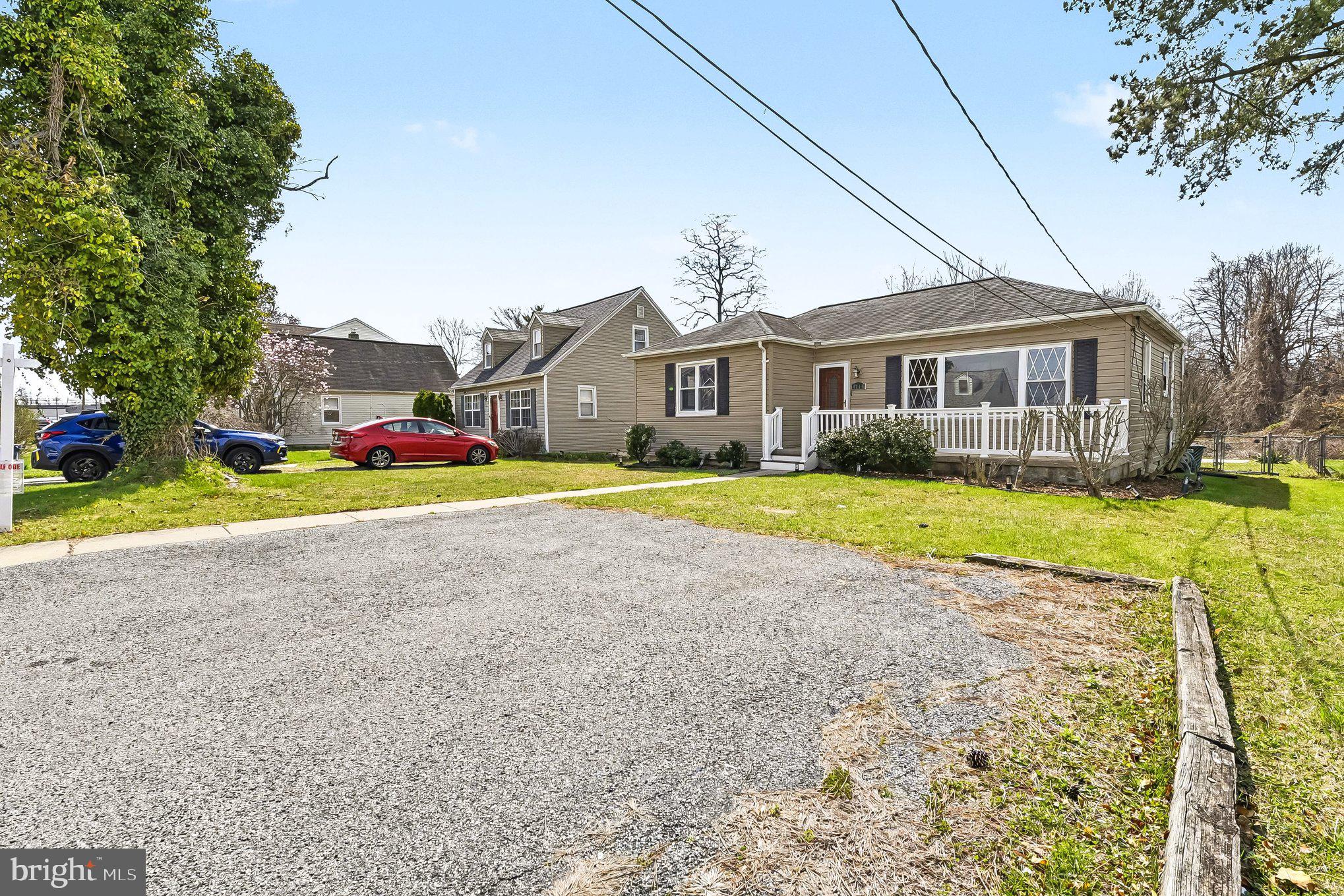 8716 Eddington Road Parkville, MD 21234 - Photo 18 of 27 a view of a house with a big yard and large trees