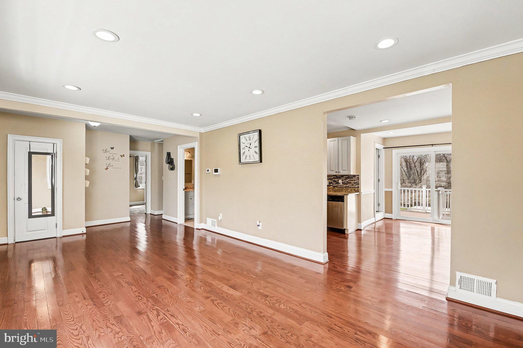 8716 Eddington Road Parkville, MD 21234 - Photo 19 of 27 a view of an empty room with wooden floor and a window