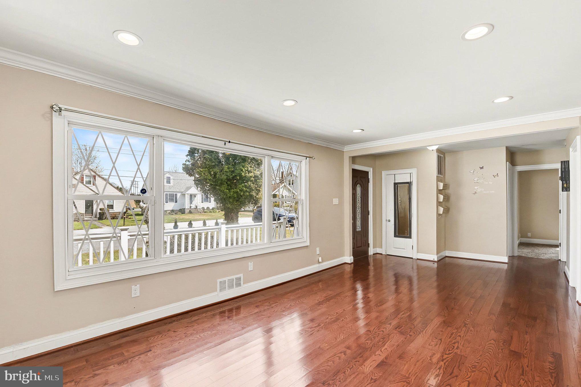 8716 Eddington Road Parkville, MD 21234 - Photo 20 of 27 a view of an empty room with wooden floor and a window