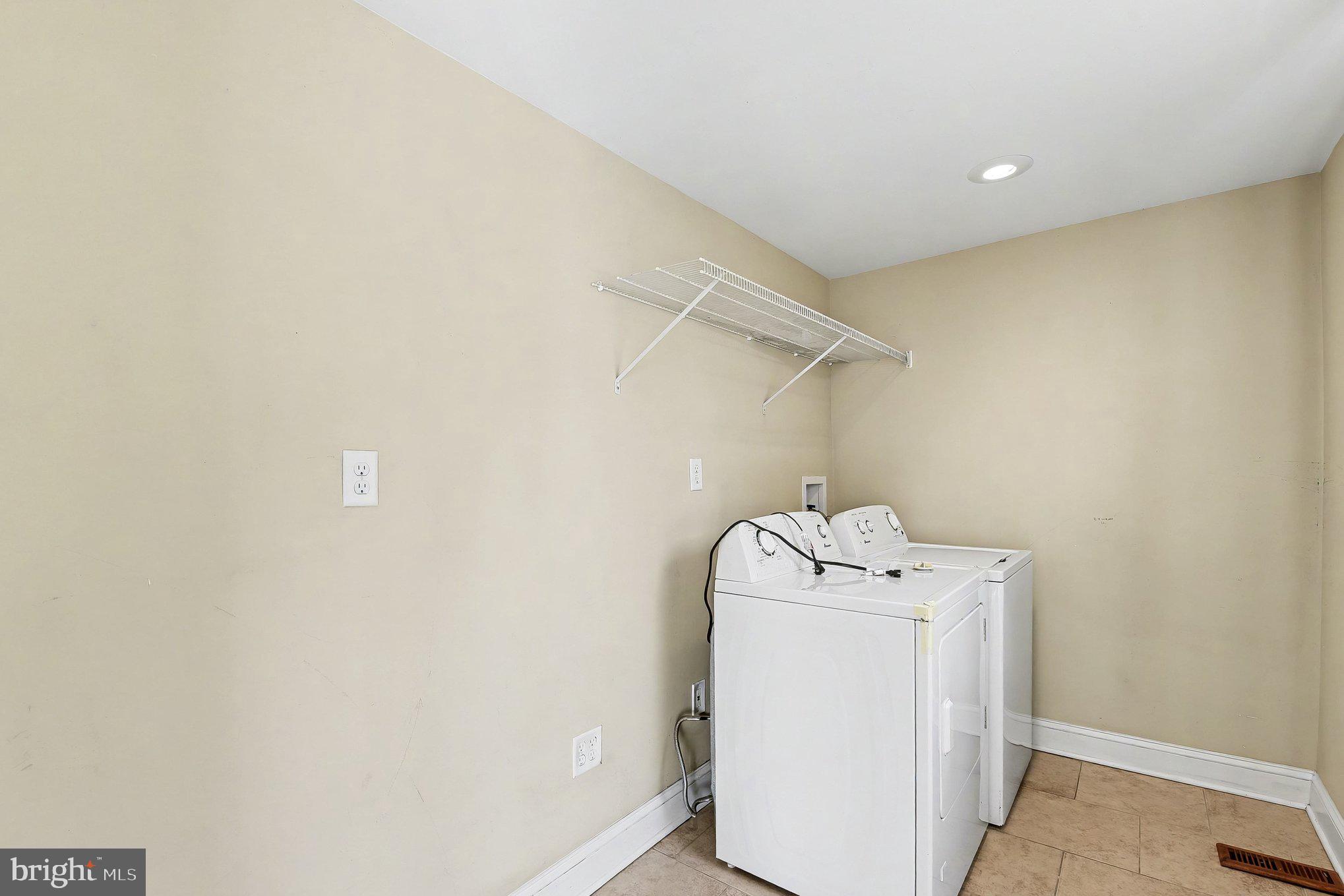 8716 Eddington Road Parkville, MD 21234 - Photo 23 of 27 a utility room with dryer and washer