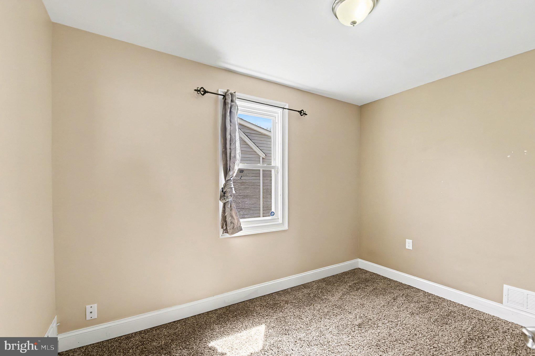 8716 Eddington Road Parkville, MD 21234 - Photo 26 of 27 an empty room with a window