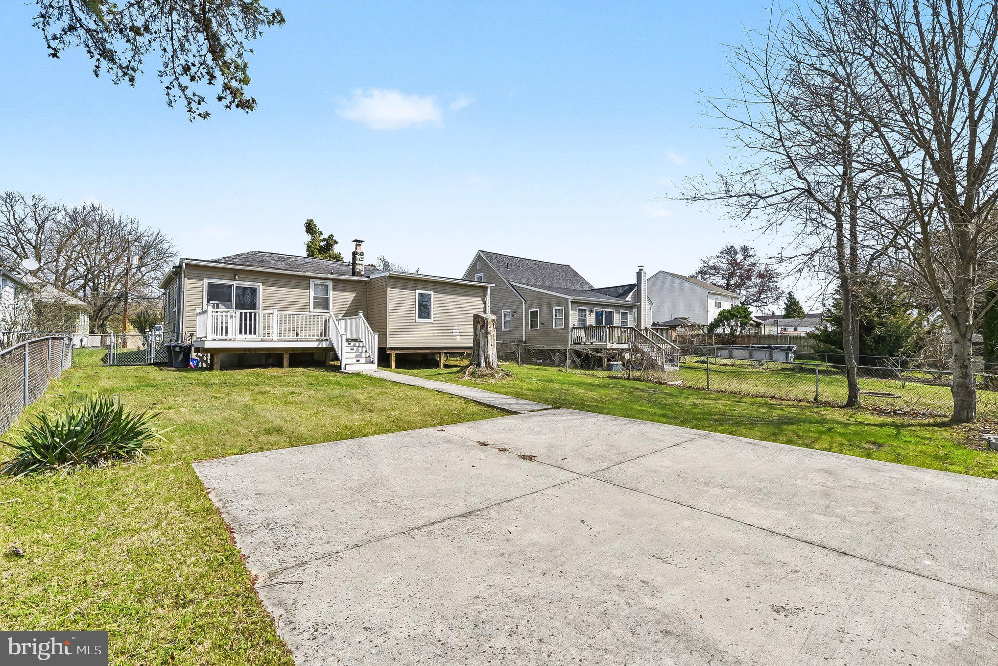 8716 Eddington Road Parkville, MD 21234 - Photo 27 of 27 a view of a big house with a big yard and large trees