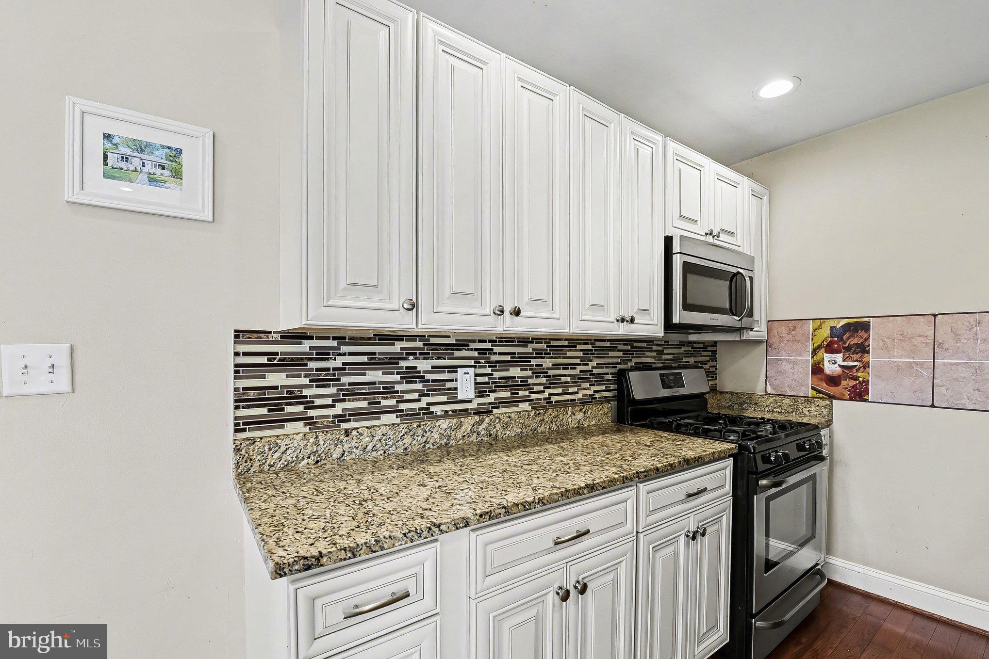8716 Eddington Road Parkville, MD 21234 - Photo 8 of 27 a kitchen with sink cabinets and microwave