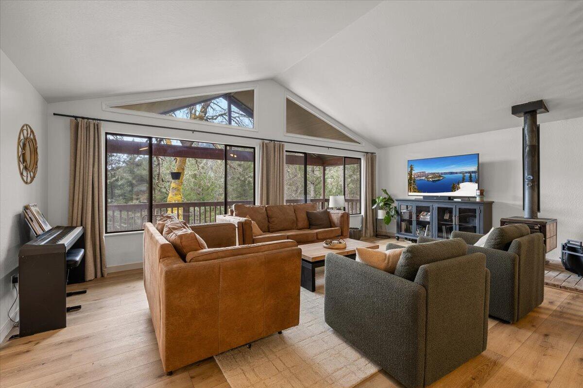 350 Splendor Drive Wilderville, OR 97543 - Photo 11 of 57 a living room with furniture a large window and a flat screen tv