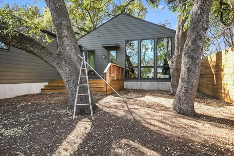 a backyard of a house with barbeque oven and outdoor seating