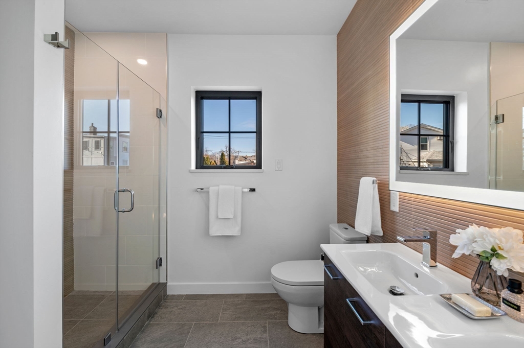 11 Boynton Street, Unit 101 Swampscott, MA 01907 - Photo 27 of 42 a bathroom with a sink toilet and shower