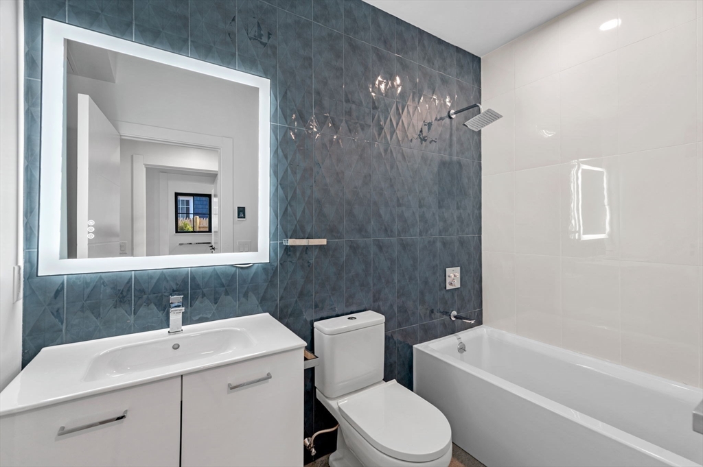 11 Boynton Street, Unit 101 Swampscott, MA 01907 - Photo 33 of 42 a bathroom with a sink toilet and shower