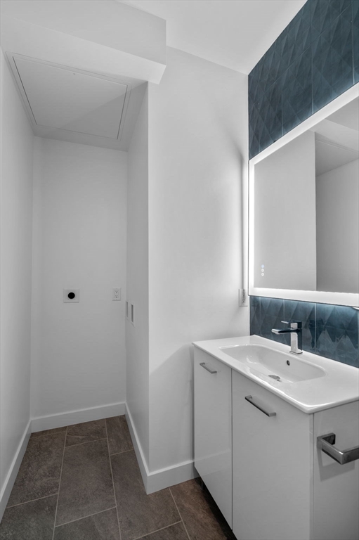 11 Boynton Street, Unit 101 Swampscott, MA 01907 - Photo 35 of 42 a bathroom with a sink and a mirror
