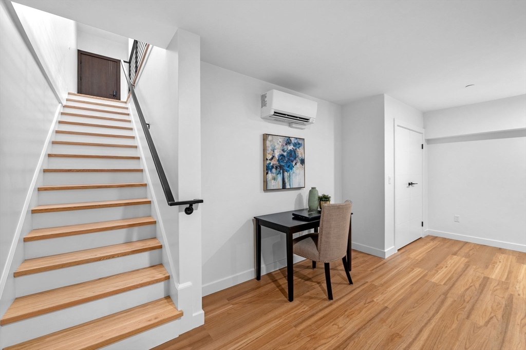 11 Boynton Street, Unit 101 Swampscott, MA 01907 - Photo 36 of 42 a view of a livingroom with wooden floor and chair