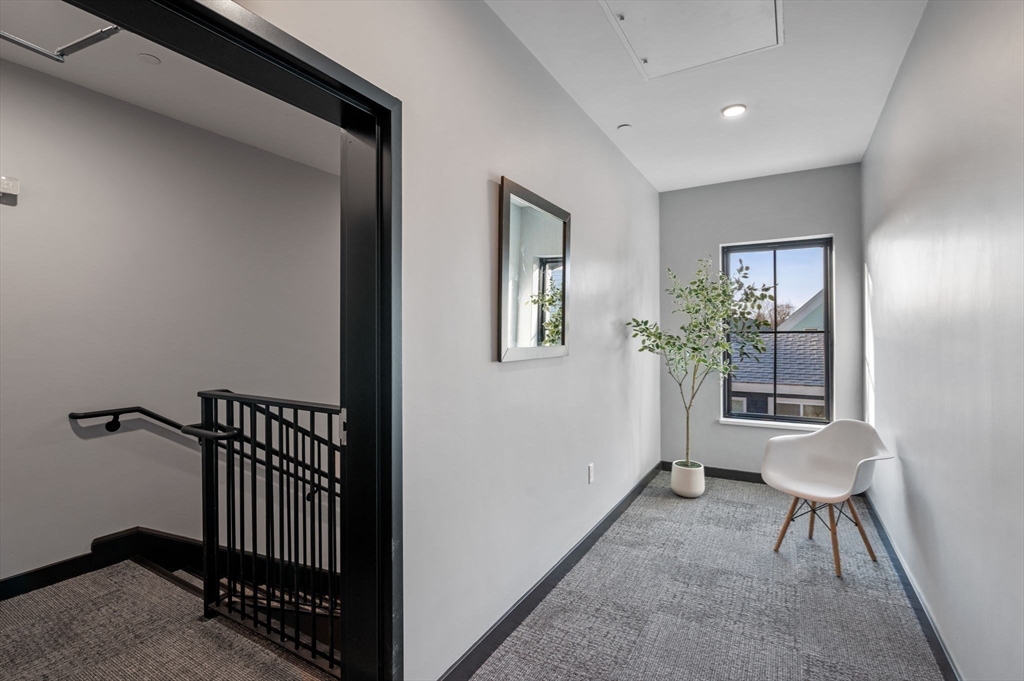 11 Boynton Street, Unit 101 Swampscott, MA 01907 - Photo 40 of 42 a view of a hallway with furniture and windows