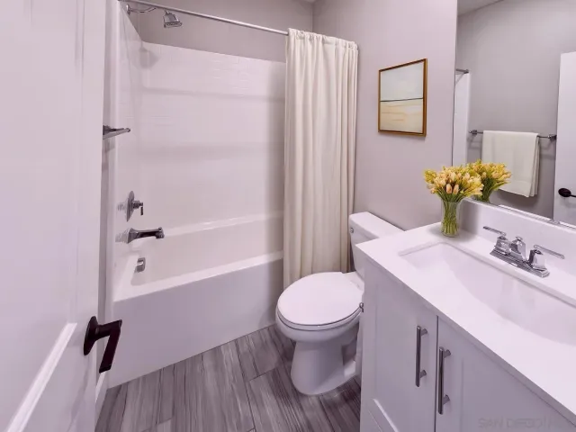 a bathroom with a sink toilet and shower
