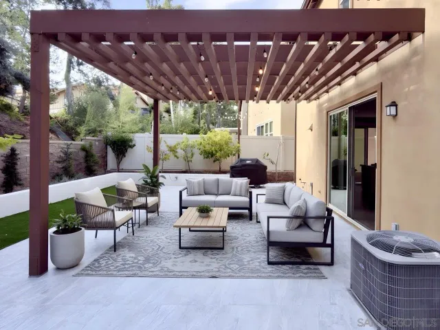 a living room with furniture and a potted plant
