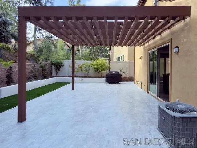 a view of an house with backyard and porch