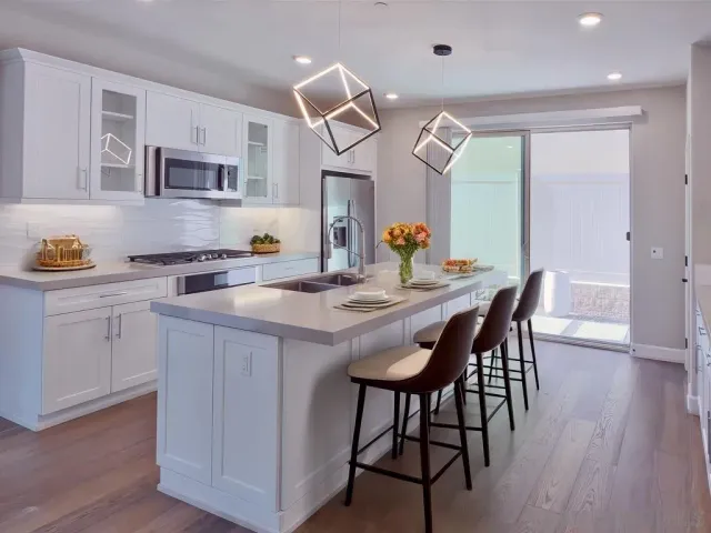 a kitchen with a table chairs and a refrigerator