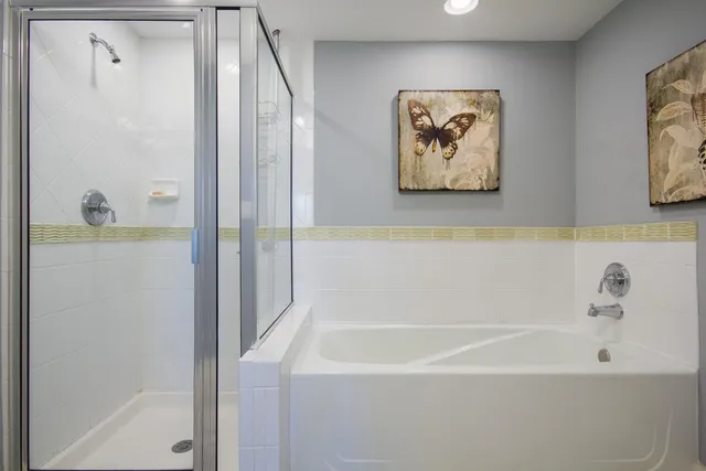 a bathroom with bathtub and shower