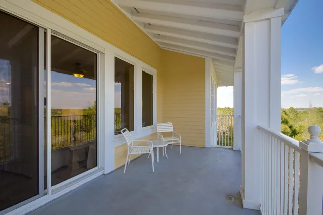 a view of a balcony with chair and front door