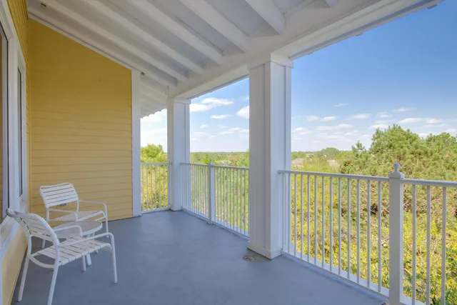 a view of a balcony with chairs