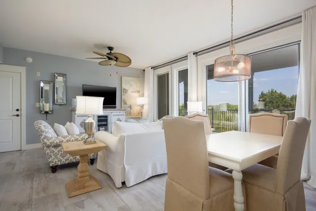 a living room with furniture a chandelier and a table