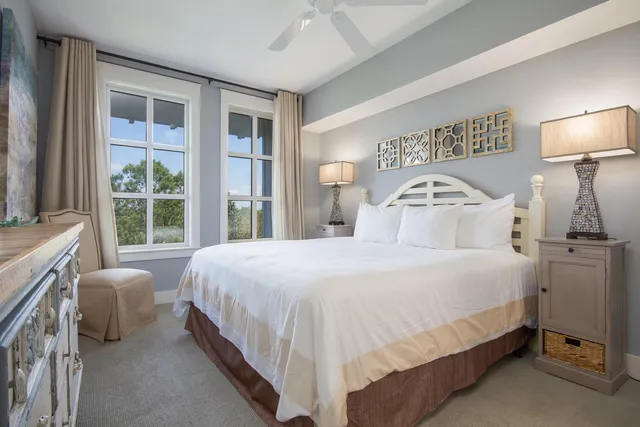 a bedroom with a bed and a large window