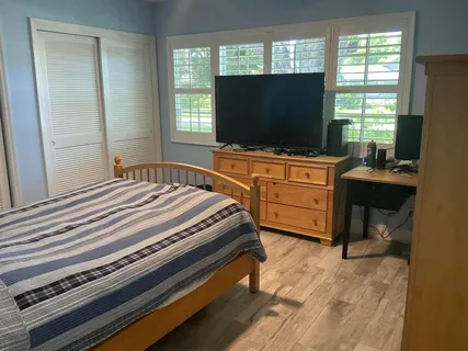 a bedroom with a bed and a flat screen tv