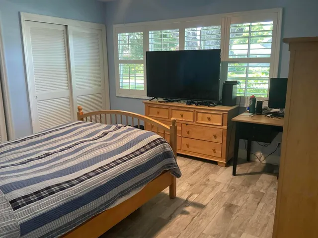 a bedroom with a bed and a flat screen tv