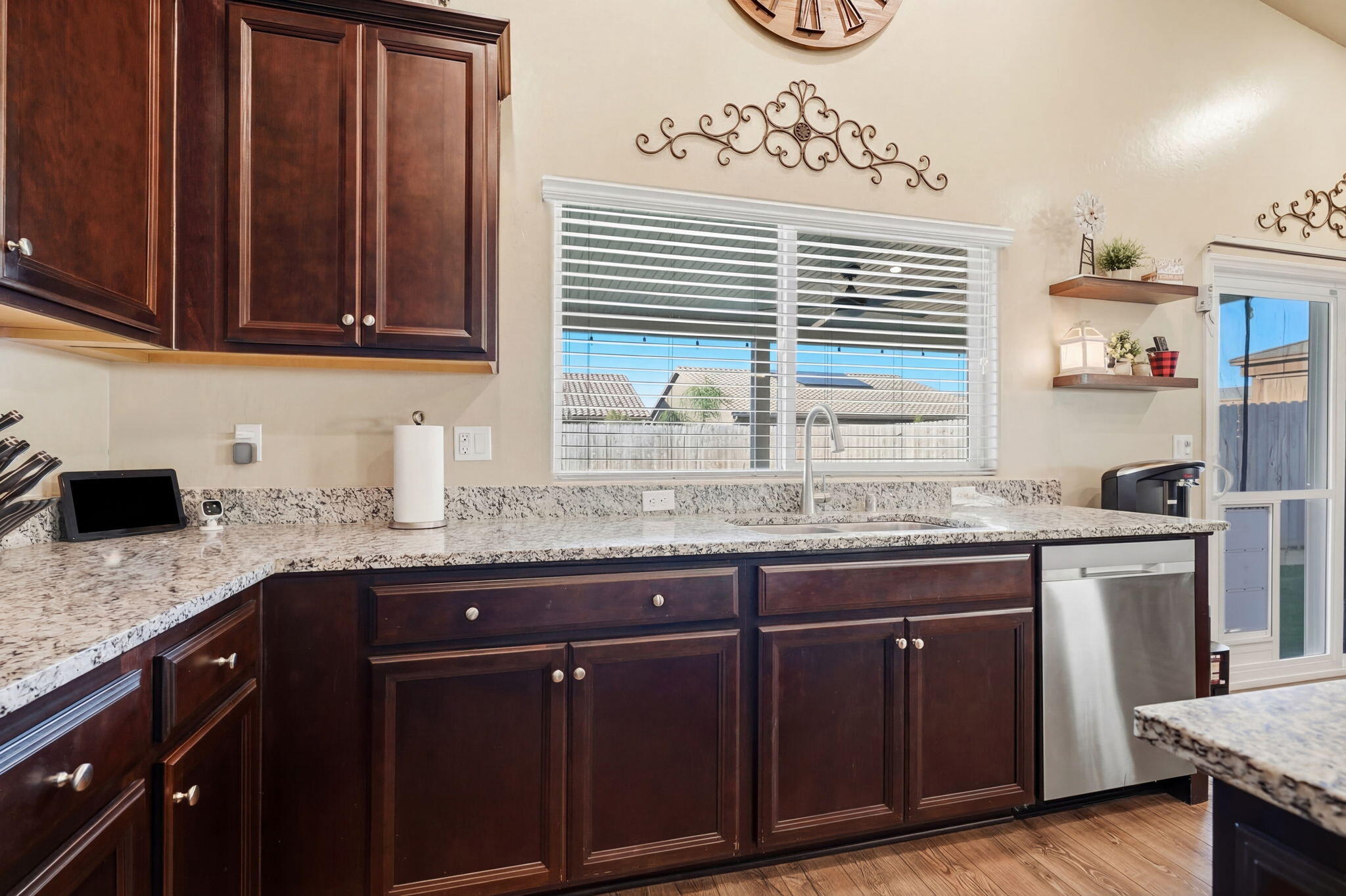 756 Strada Street Lemoore, CA 93245 - Photo 14 of 53 a kitchen with granite countertop wooden cabinets a sink and dishwasher