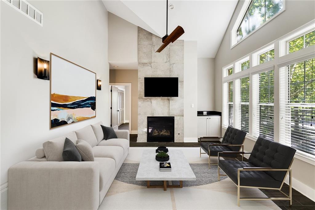 240 Renaissance Parkway Northeast, Unit 214 Atlanta, GA 30308 - Photo 1 of 1 a living room with furniture a fireplace and a flat screen tv