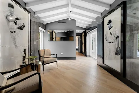 a spacious bedroom with a bed a chandelier and a large window