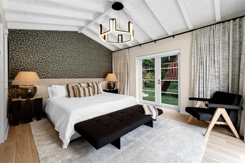 a bedroom with furniture and a large mirror