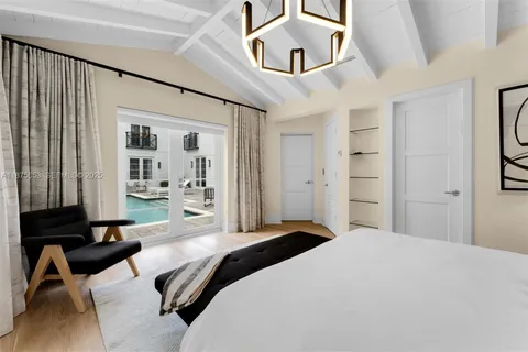 a bedroom with furniture and a large mirror