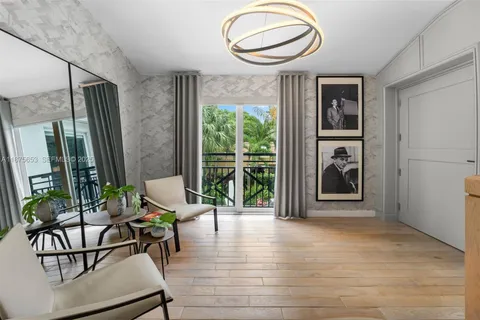 a view of a livingroom with furniture and floor to ceiling window