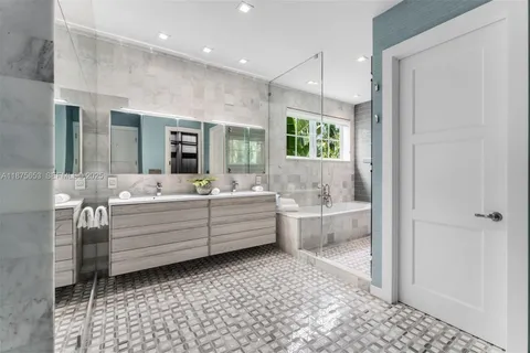 a bathroom with a bathtub sink and mirror