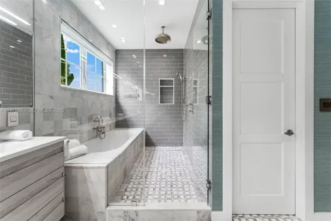 a bathroom with a bathtub and a sink