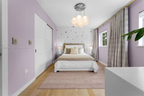 a bed room with a bed and a chandelier