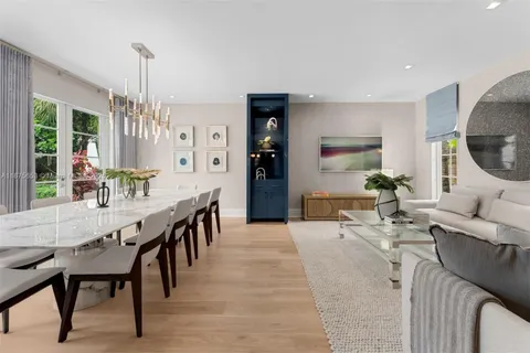 a living room with furniture fireplace and a large window