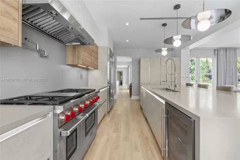a kitchen with stainless steel appliances granite countertop a stove and a sink