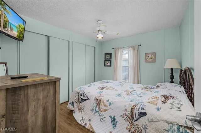 a spacious bedroom with a bed and a chandelier