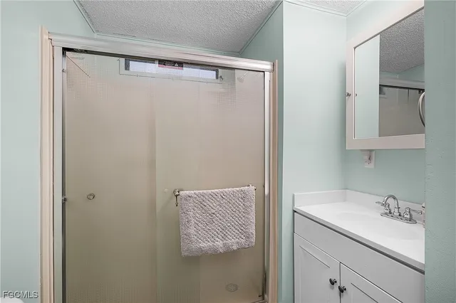 a bathroom with a shower and a sink