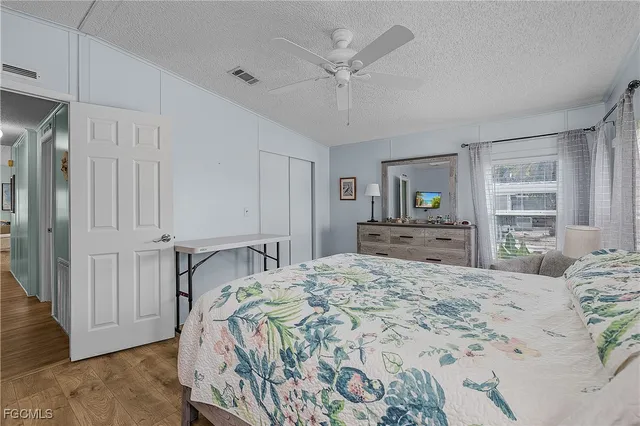 a bedroom with a large bed and a dresser