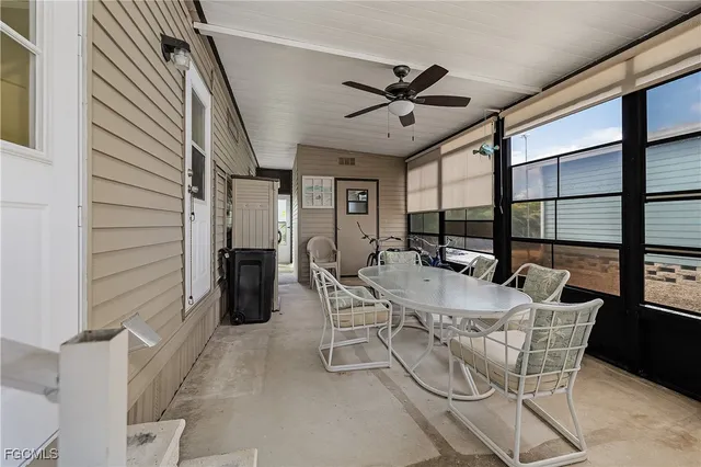 a dining room with furniture and a large window