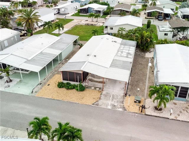an aerial view of a house with a yard and potted plants