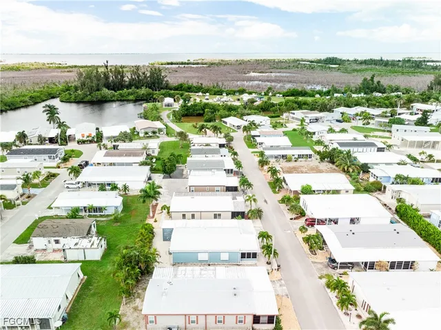 an aerial view of residential houses with outdoor space and river