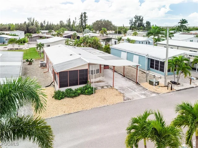 a view of a house with a yard and lake view