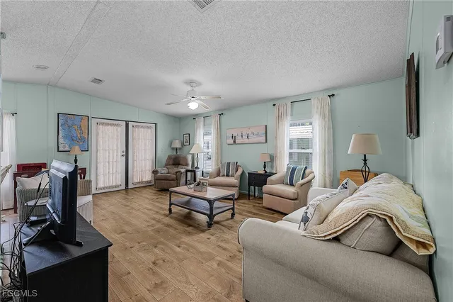 a living room with furniture a couch and a flat screen tv