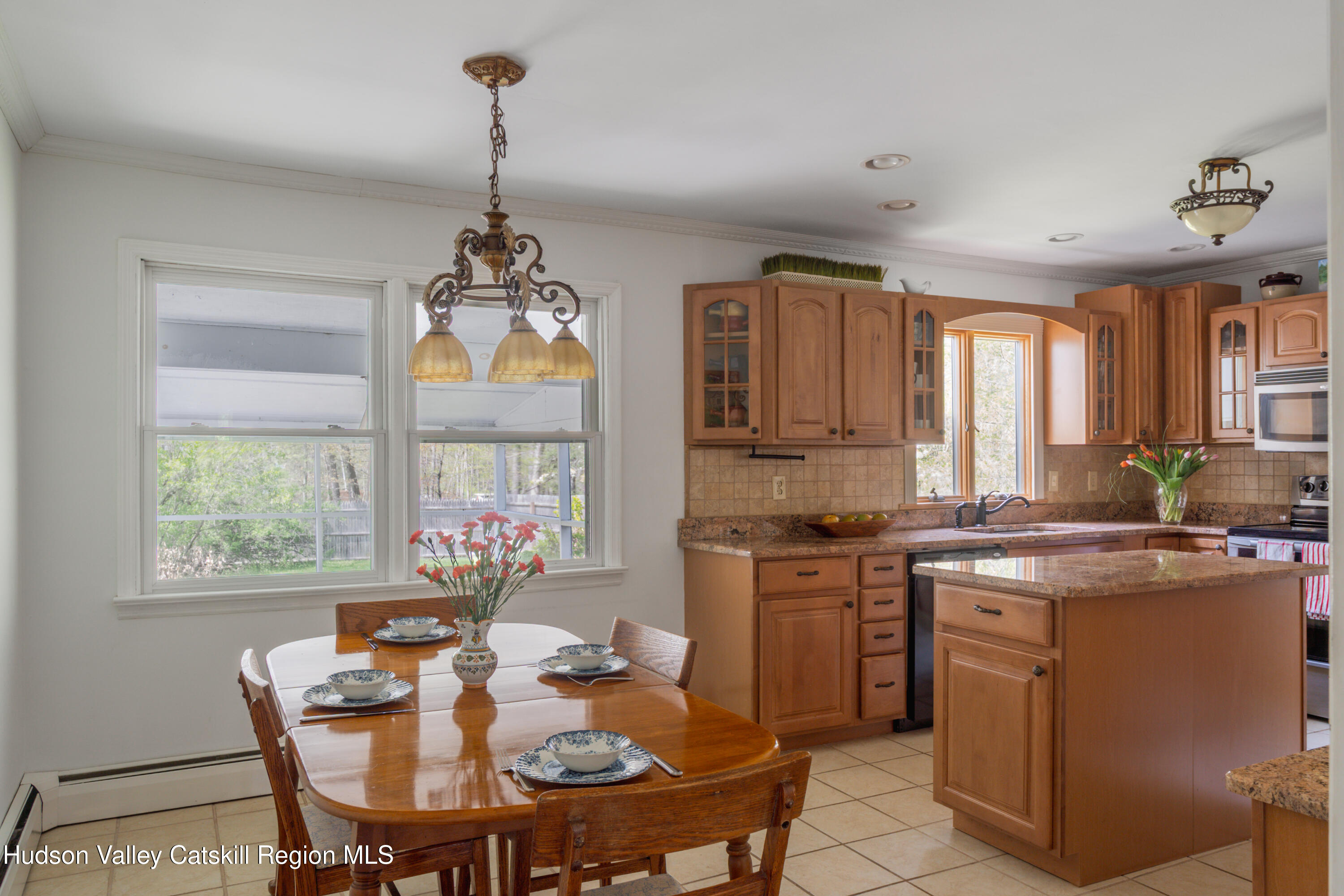 1 Stone Ridge Court Woodstock, NY 12498 - Photo 12 of 30 a kitchen that has a stove a table and chairs in it