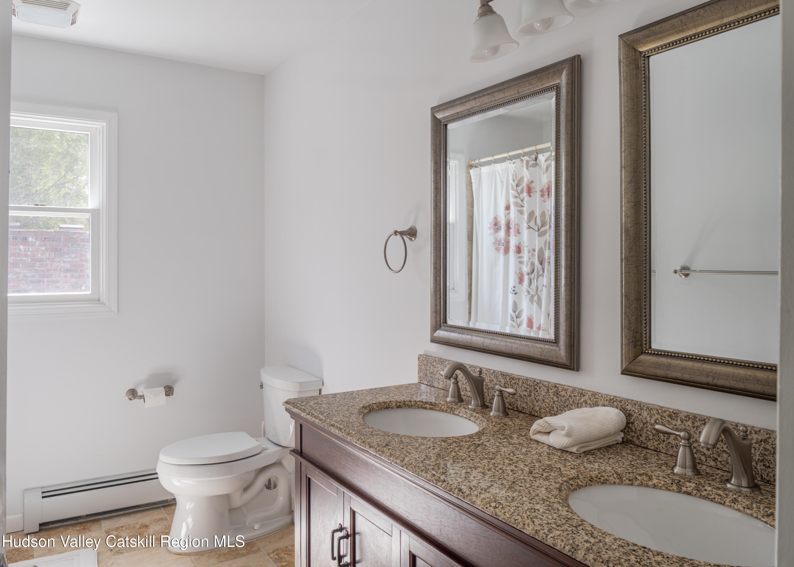 1 Stone Ridge Court Woodstock, NY 12498 - Photo 21 of 30 a bathroom with a granite countertop toilet a sink and a mirror