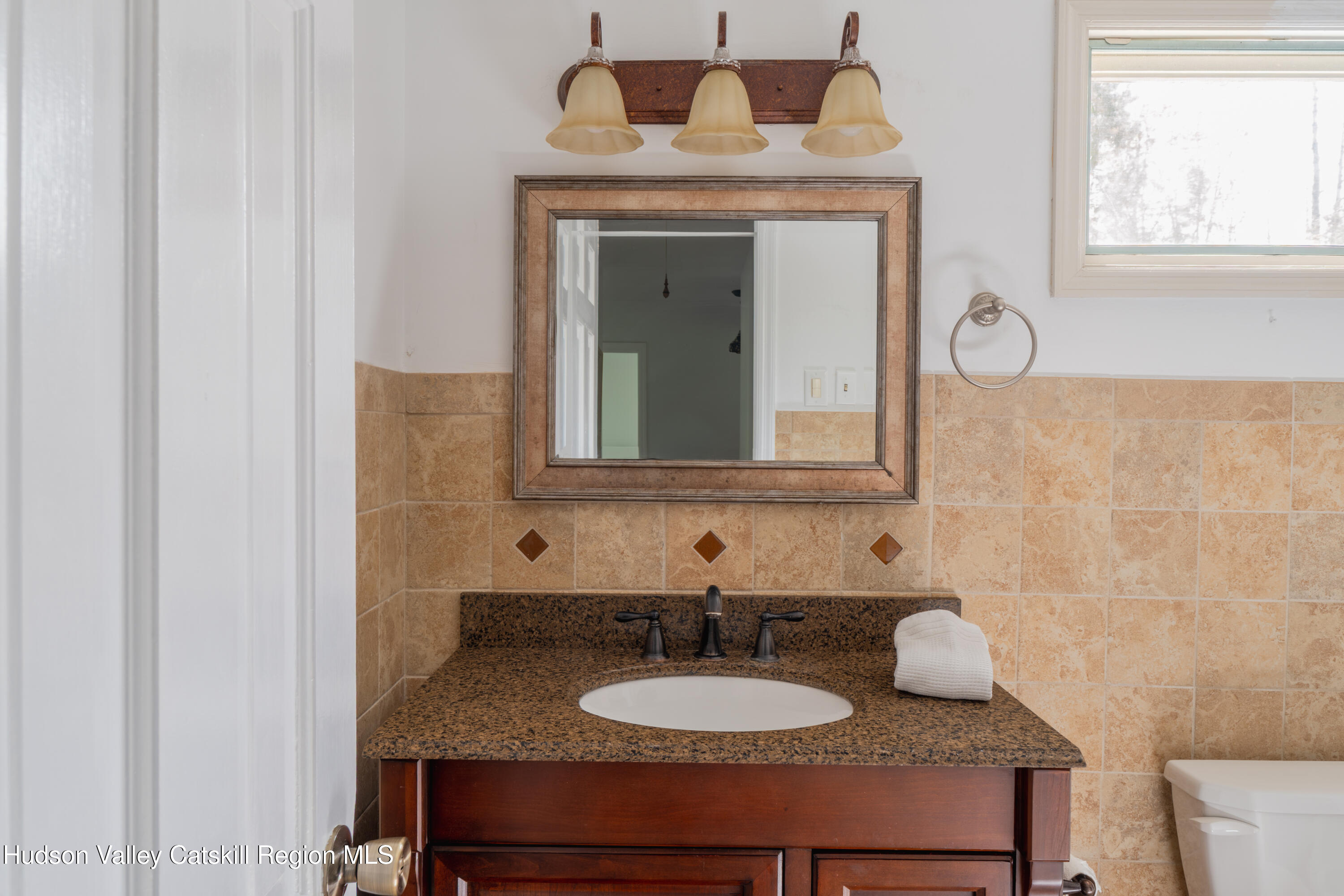 1 Stone Ridge Court Woodstock, NY 12498 - Photo 23 of 30 a bathroom with a granite countertop sink and a mirror